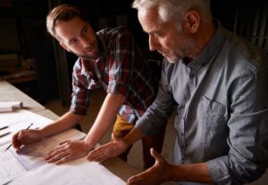 Two men looking at plans.